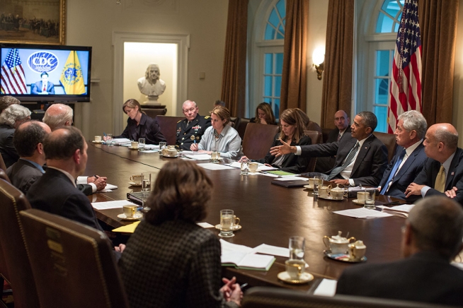 Photo: (Official White House Photo by Pete Souza) President Barack Obama convenes a meeting with cabinet agencies coordinating the government's Ebola response, in the Cabinet Room of the White House, Oct.15, 2014.