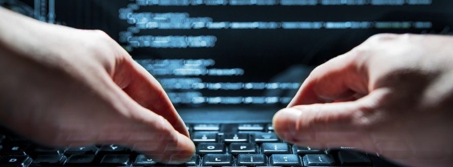 Hacker using laptop. Lots of digits on the computer screen.