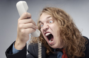 Crazy businessman screaming to the phone