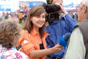 young woman journalist is interviewing on Baikal Day on August 3, 2008 at Baikal Lake, Buryatia, Russia