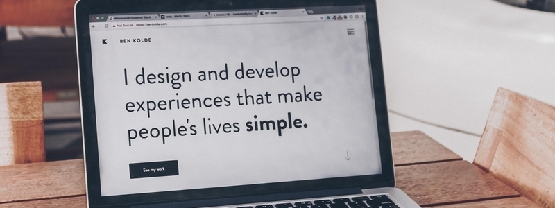 A picture of a laptop with the text "I design and develop experiences that make people's lives simple."