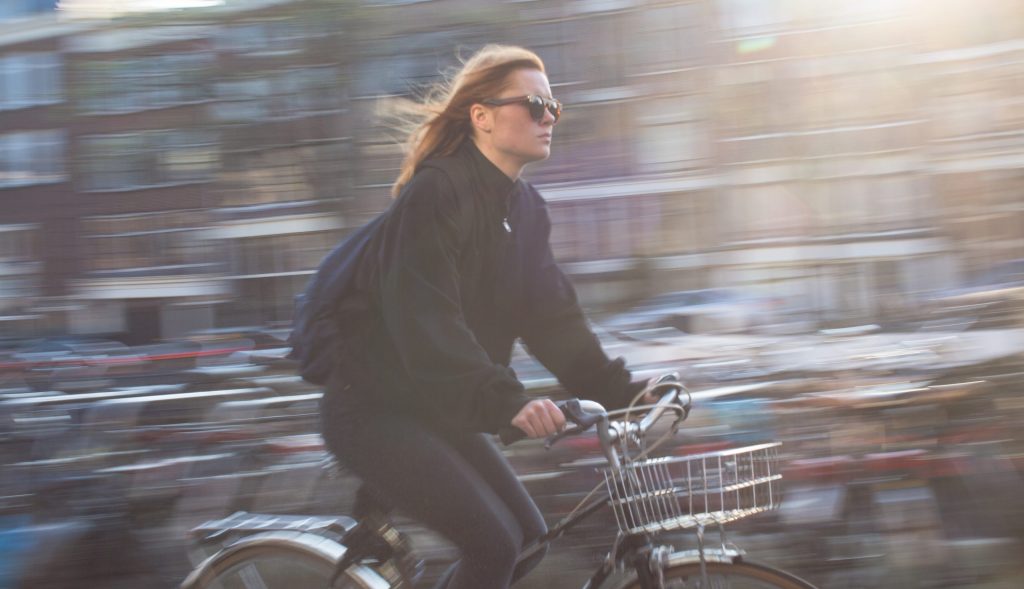 Bicyclist with blurred urban background