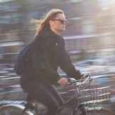 Bicyclist with blurred urban background
