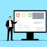 Employee gesturing to computer screen with customer survey on it.