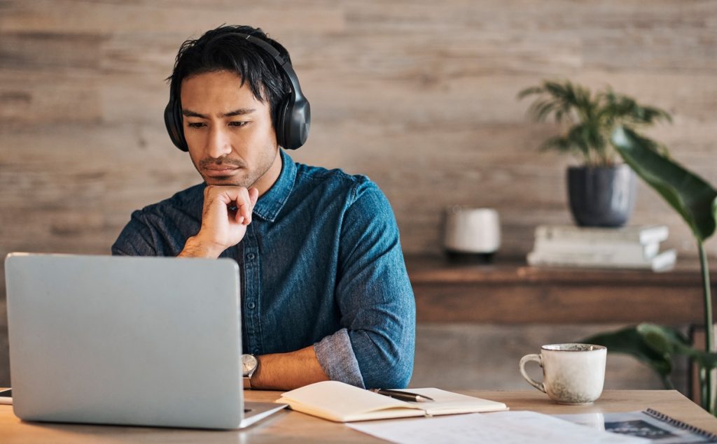 Man at laptop with headphones on