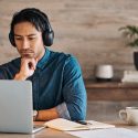 Man at laptop with headphones on