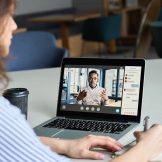 Woman listens to online training seminar.