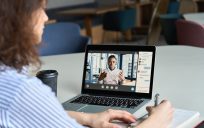 Woman listens to online training seminar.