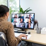 Woman at computer in online meeting.
