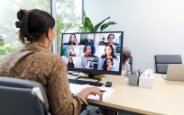 Woman at computer in online meeting.