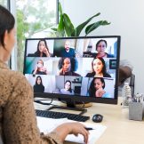 Woman at computer in online meeting.