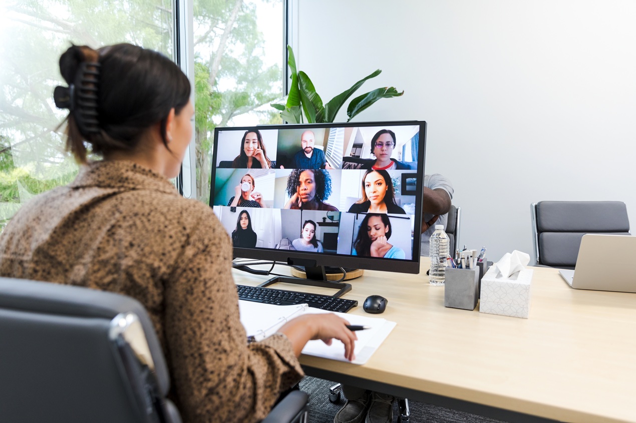 Woman at computer in online meeting.
