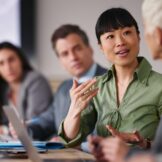 Woman leading meeting in office.