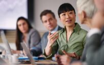 Woman leading meeting in office.